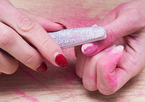 nail dust created by filing off gel polish from fingernails