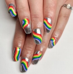 Rainbow festival nails created by Bekki Woolnough, Glitter and art gels. Styled in Glitters nail art representing Holiday. These Medium - Coffin shaped nails are crafted using the Gel Polish system and are coloured Multi.