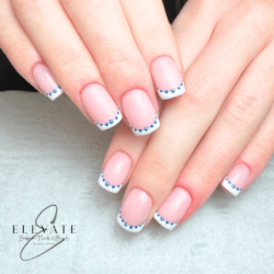 Evil eye nails created by Emma Brandreth, Buildergel overlay, hand painted French with dots to create evil eye symbol. Styled in French nail art representing Holiday. These Short - Squoval shaped nails are crafted using the Builder system and are coloured Blue.