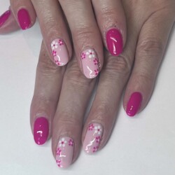 Pink Floral  created by Natalie Morris.Styled in Free Hand Flowers  nail art representing Floral. These Medium - Round shaped nails are crafted using the Gel Polish system and are coloured Pink. 