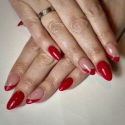 Classic Red created by Natalie Morris.Styled in French nail art representing Minimalistic. These Medium - Almond shaped nails are crafted using the Acrylic system and are coloured Red. 