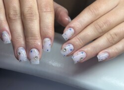 starry night milky white created by Áislin Fitzsimons.Styled in Mixed Media nail art representing Galaxy / Space. These Medium - Square shaped nails are crafted using the Acrylic system and are coloured White. 